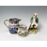 A 19th century blue and white transfer printed jug, a Staffordshire pearlware figure and a