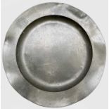 A pewter charger, 19th century, of circular form with touchmarks to base, diameter 38.5cm.