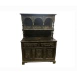 A Victorian carved oak buffet, the upper part with a single tier surmounted by four turned