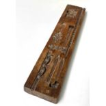 A 19th century treen gingerbread mould, 33.5 x 6.5cm. Provenance:Michael Trethewey. A Gentleman of