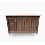 An oak blanket box, 20th century, with a quadruple panelled front on bun feet, height 66cm, width