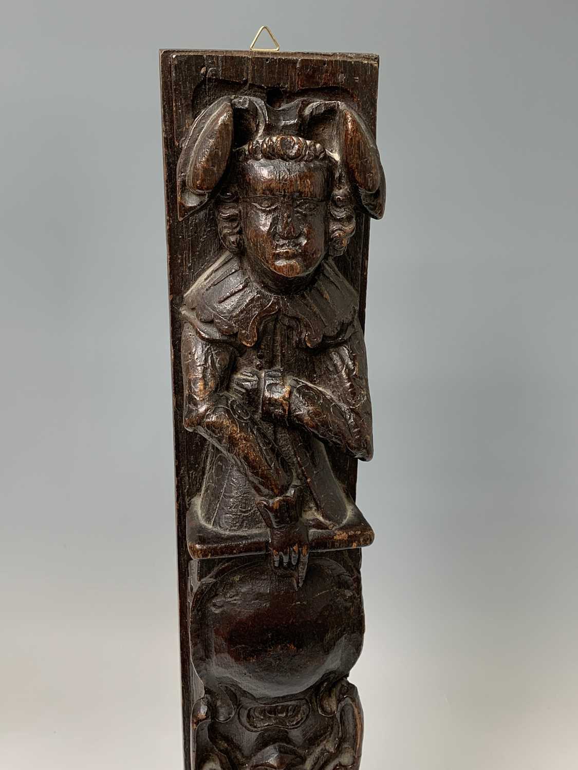 An oak carved oak term panel, 16th century, depicting a male figure rising above a vacant - Image 3 of 10