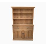 An early 20th century pine dresser, the lower part with two drawers and two panelled cupboard doors,