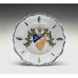 A French tin glazed earthenware dish, early 19th century, polychrome painted with a shield, diameter