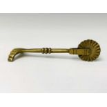 An early 19th century brass pastry jigger, length 10.3cm.