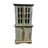 A French rustic blue and white painted cabinet, with a pair of glazed doors, the lower part with a