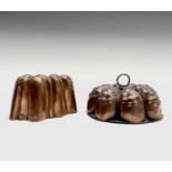 Two Victorian copper jelly moulds, one with a brass handle, height 7cm, diameter 16.5cm, the other