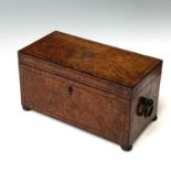 An early 19th century burr walnut tea caddy, the interior fitted with a glass mixing and two