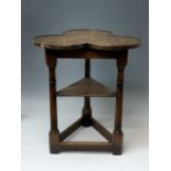 An oak cricket table, 20th century, the lobed top on ring turned legs joined by an undertier and