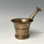 An 18th century bronze pestle and mortar, height of mortar 11cm, diameter 14cm. Provenance:Michael