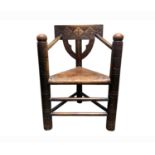A pine Turners chair, 19th century, the rectangular top rail carved with cross motifs, above a