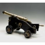 A bronze signalling cannon, early 19th century, raised on a later oak carriage, height 30cm,