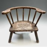 A beech and elm stick back primitive child's chair, 19th century, bearing traces of original