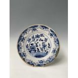An English delft dish, mid 18th century, painted in blue with flowering plants, diameter 30cm.
