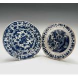 A Dutch Delft dish, 18th century, blue painted with floral decoration, diameter 22cm and another,