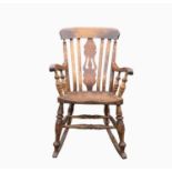 A Victorian beech and elm lathe back rocking chair, with a central pierced splat, solid elm seat, on