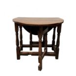 A George I oak gateleg table, of small proportions, the oval top on turned legs and square