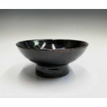 Trevor CORSER (1938-2015) A footed dish, tenmoku glaze Impressed marks to base Diameter 22cm, height