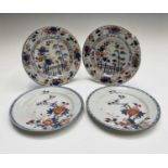 A pair of Chinese Imari porcelain plates, 18th century, each with a bird in a flowering tree,