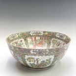 A large Chinese Canton porcelain punch bowl, 19th century, decorated to interior and exterior with