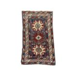 A Lesghi Shirvan rug, the indigo field with three polychrome medallions, octagonal guls and