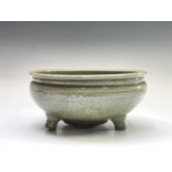 A Chinese Longquan celadon tripod censer, Ming dynasty, with an olive green crackle glaze, the outer