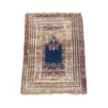 A Ghiordes Prayer rug, West Anatolia, circa 1800, the indigo mihrab with vases of flowers, guls