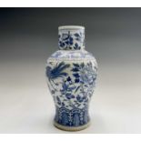 A Chinese porcelain blue and white baluster vase, 19th century, decorated with flowering branches