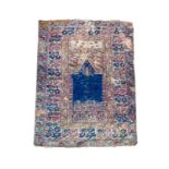 A Ghiordes Prayer rug, West Anatolia, the indigo mihrab, foliage and guls, within an ivory