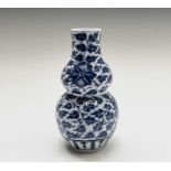 A Chinese porcelain blue and white double gourd vase, 19th century, with Kangxi four character mark,