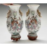 A pair of Chinese famille rose porcelain wall pockets, 19th century, decorated with figures in a