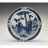 A Chinese porcelain blue and white charger, 19th century, depicting three figures beneath a tree,