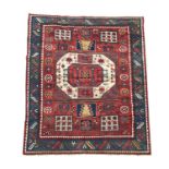 A Karachov Kazak rug, circa 1880, the madder field with a large ivory central octagonal medallion