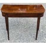 A late George III mahogany and crossbanded fold top card table, raised on square taper legs,