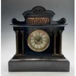 A black slate mantel clock, late 19th century, with inset copper plaque depicting Classical