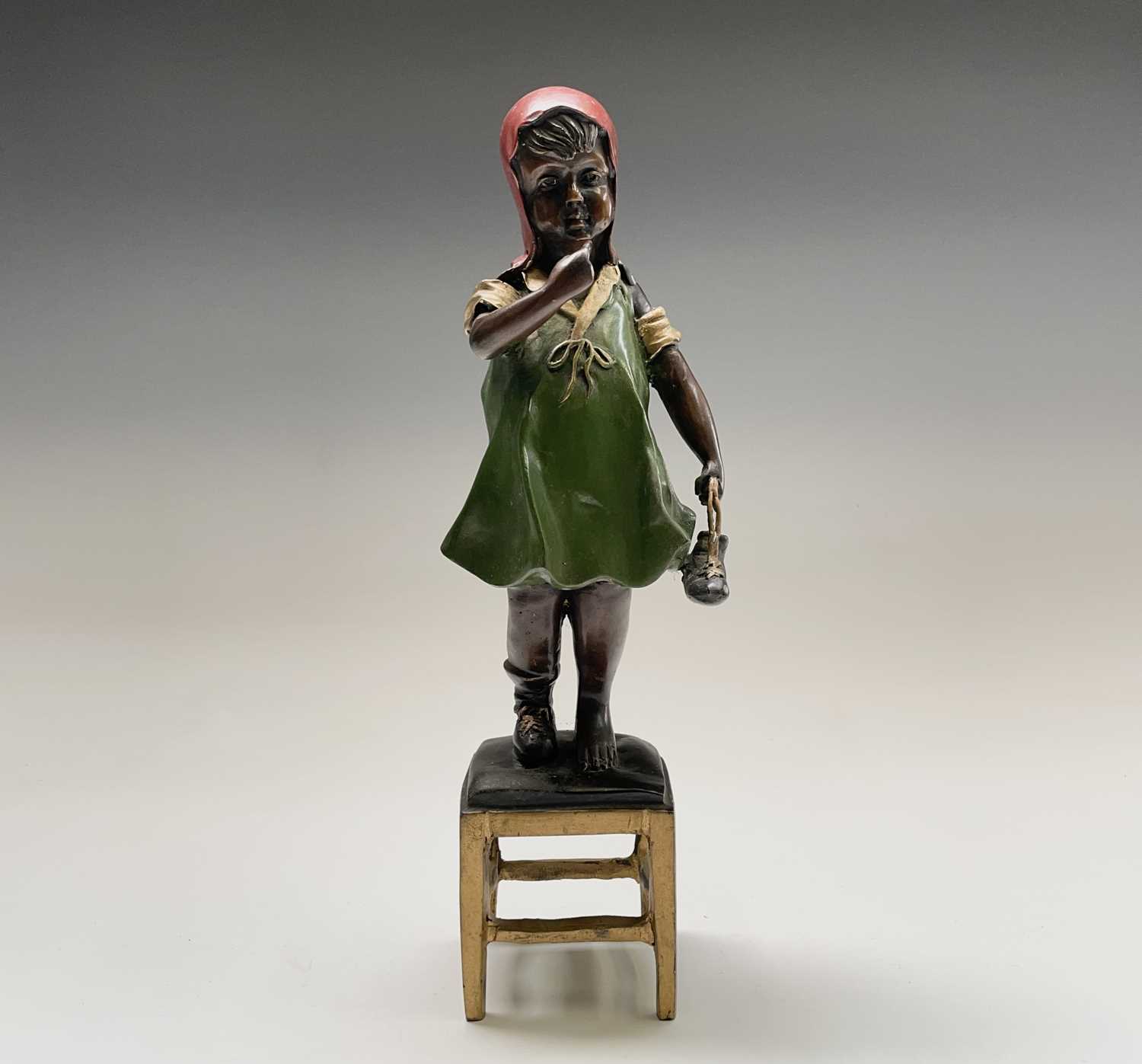 After Juan Clena, a painted bronze sculpture of a girl standing on a stool. Height 37cm.