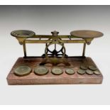 A set of late Victorian Sampson Mordan & Co brass and oak postal scales, the base set with nine