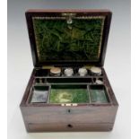 A Victorian rosewood toilet box, fitted with jars and compartments and a lower drawer, width 31cm.