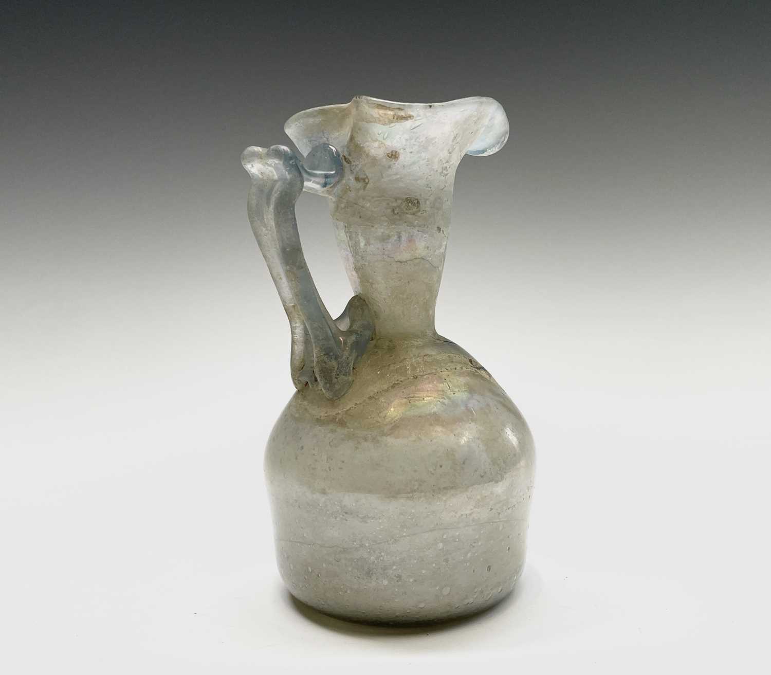 Three iridescent glass vessels, possibly Roman, comprising a ewer, height 13cm, and two vases. - Image 8 of 16