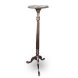A mahogany torchere, of George III design, 1920s, with turned and fluted column on tripod base,