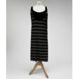 A MCQ by Alexandra McQueen sleeveless black dress, with raised gold dot horizontal banded