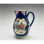 A Worcester jug, circa 1770, the blue scale ground decorated with gilt edged floral panels, crescent