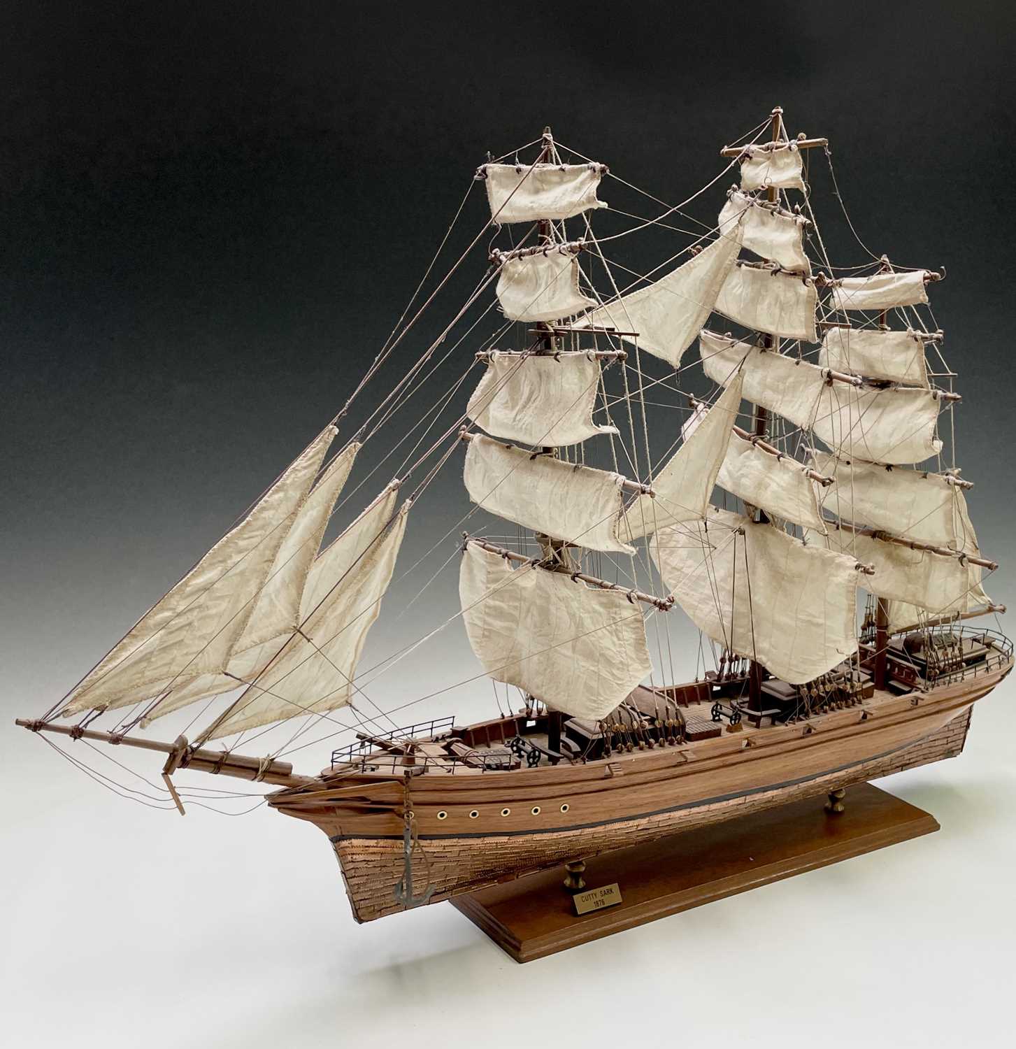 A wooden model of the clipper Cutty Sark, with copper clad hull, titled and mounted on a rectangular