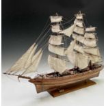 A wooden model of the clipper Cutty Sark, with copper clad hull, titled and mounted on a rectangular