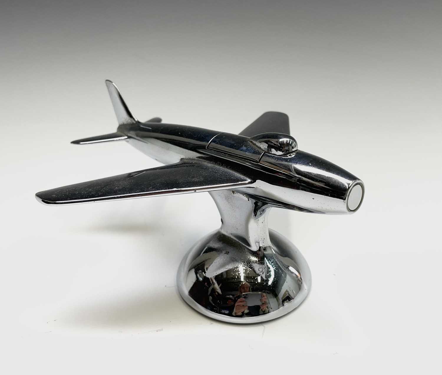 A Dunhill 'Sabre' jet fighter table lighter, 1950s, with chrome finish, on a domed base, length 16.