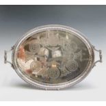 A late Victorian silver plated oval tray, engraved with foliate roundels and festoons, with