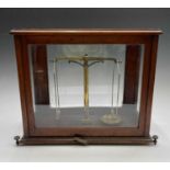 A brass precision laboratory balance, by W & T Avery Ltd, circa 1900, contained in a glazed mahogany