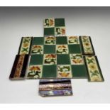 Five Art Nouveau period tiles of square form decorated with stylized flowers, 15 x 15cm, three tiles