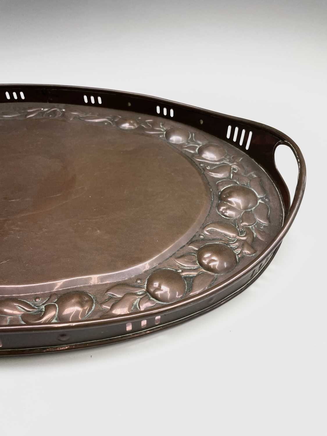 A Newlyn copper oval tray, circa 1910, the raised edge with twin handles, the border repousse - Image 6 of 8