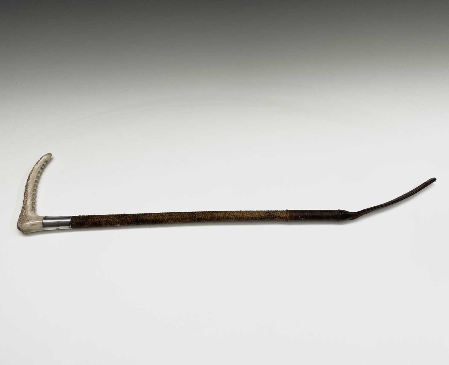 A Swaine hunting whip, with antler grip, hallmarked collar engraved with initials 'P.M.R', and